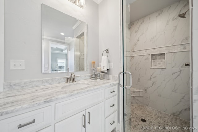 bathroom with a shower stall and vanity