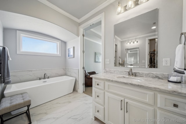 bathroom featuring vanity, marble finish floor, a spacious closet, crown molding, and a freestanding bath