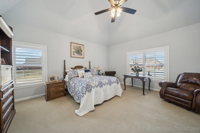 bedroom with lofted ceiling, ceiling fan, baseboards, and light colored carpet