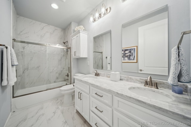 full bath with double vanity, marble finish floor, enclosed tub / shower combo, and a sink