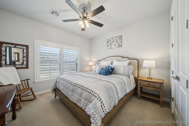 bedroom featuring visible vents, baseboards, a ceiling fan, and light colored carpet