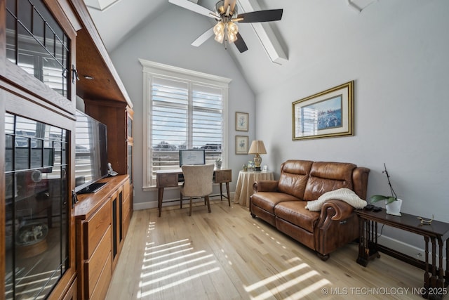 living area featuring ceiling fan, high vaulted ceiling, light wood finished floors, and baseboards