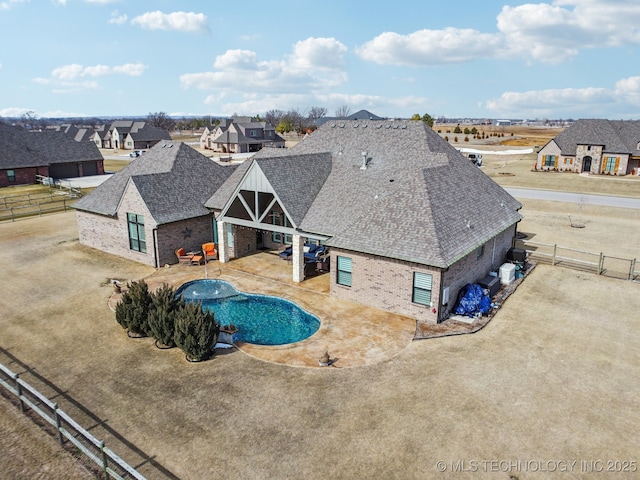 view of swimming pool featuring a patio area, a fenced backyard, a residential view, and a fenced in pool