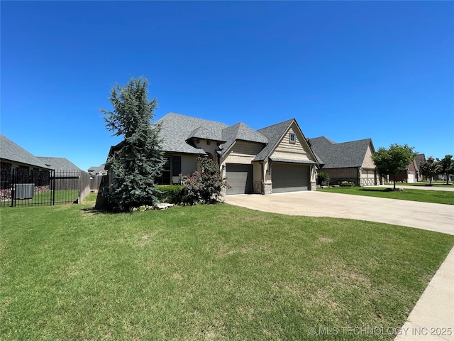 view of front of home featuring a garage, driveway, a front lawn, and fence