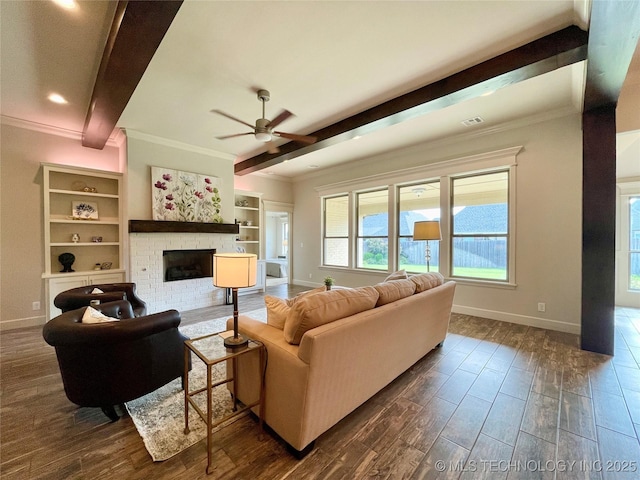 living area featuring dark wood-style flooring, beamed ceiling, a fireplace, and baseboards