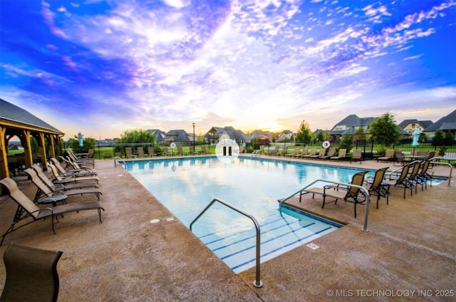 community pool featuring a patio and fence