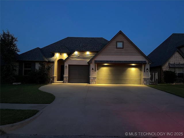 craftsman house with a garage, concrete driveway, and stone siding