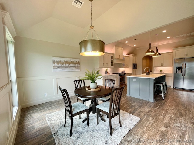 dining room with visible vents, a wainscoted wall, dark wood-style flooring, a decorative wall, and recessed lighting