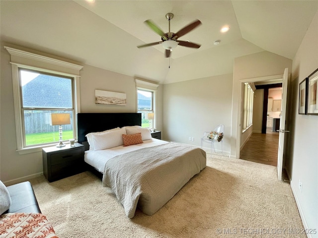 bedroom with lofted ceiling, recessed lighting, light colored carpet, ceiling fan, and baseboards