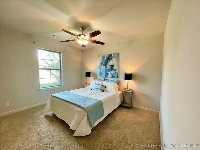 carpeted bedroom with a ceiling fan, visible vents, and baseboards