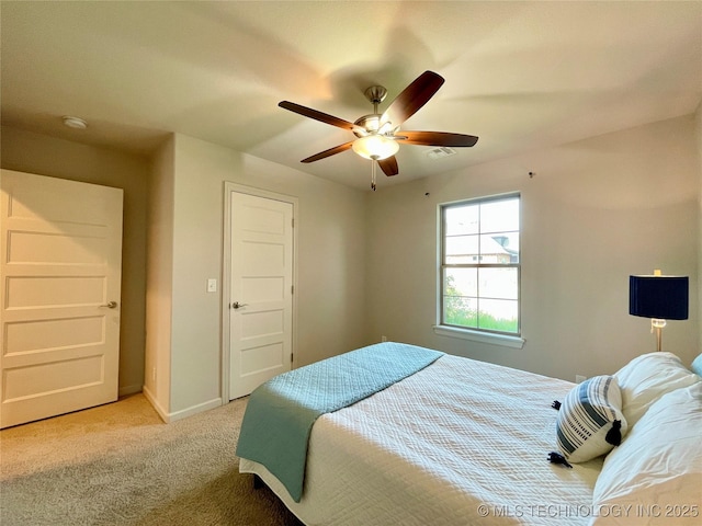 bedroom featuring light carpet, ceiling fan, and baseboards