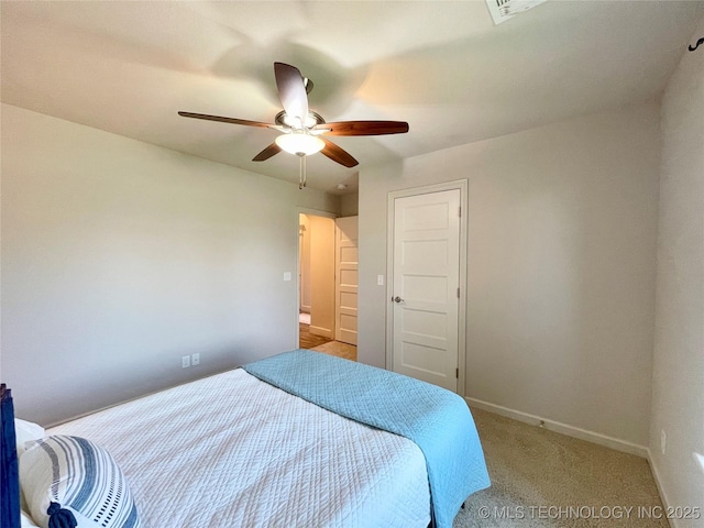 bedroom featuring light colored carpet, ceiling fan, and baseboards