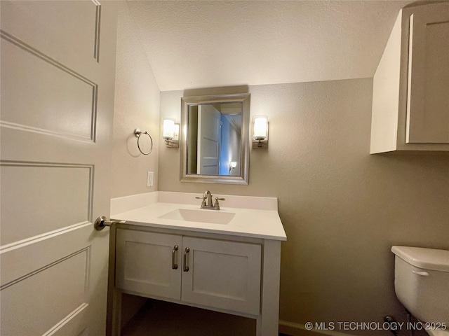 half bathroom with toilet and vanity