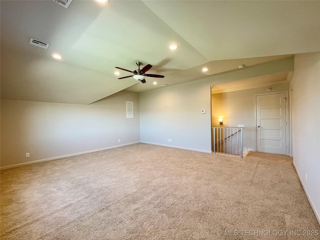 unfurnished room with lofted ceiling, light carpet, visible vents, and recessed lighting