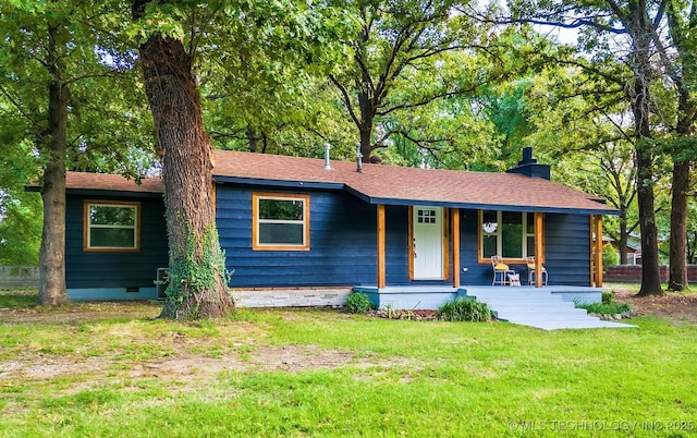 single story home featuring covered porch, a shingled roof, crawl space, a chimney, and a front yard