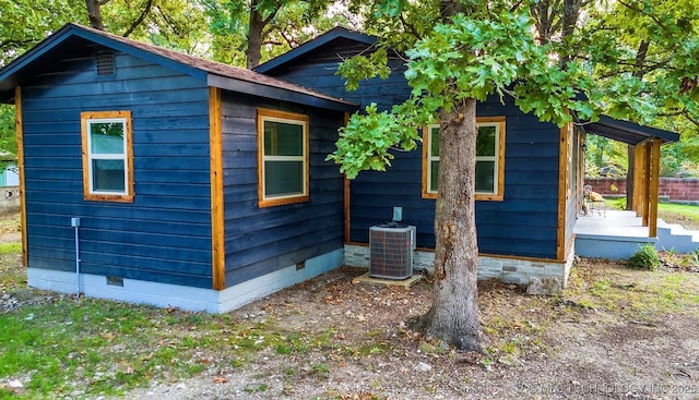 view of home's exterior with central AC and crawl space