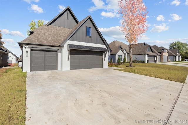 view of front of house featuring concrete driveway, a shingled roof, board and batten siding, and a front yard