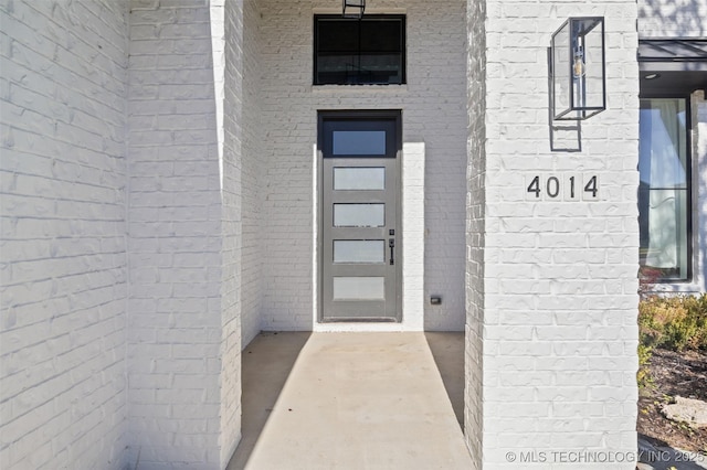 entrance to property with brick siding