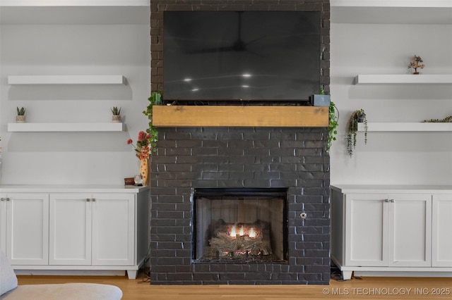 interior details with a fireplace and wood finished floors