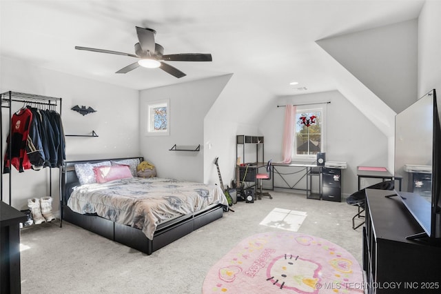 bedroom featuring vaulted ceiling, light carpet, and a ceiling fan