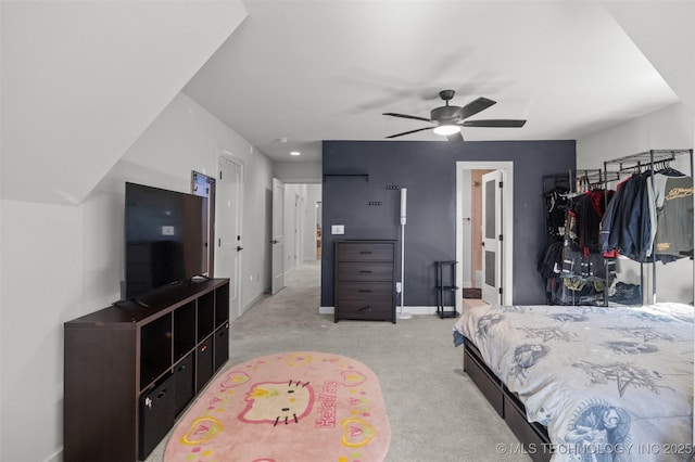 bedroom featuring light carpet, a ceiling fan, and baseboards