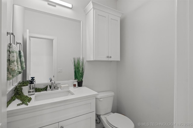 half bathroom with toilet and vanity