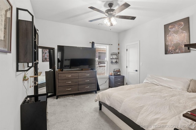 bedroom with light carpet and ceiling fan