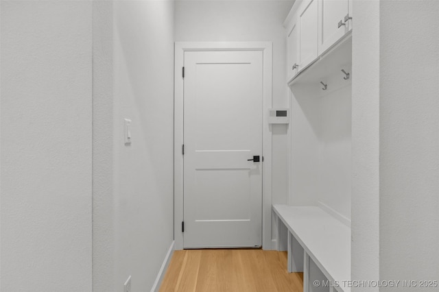 mudroom with light wood-style flooring