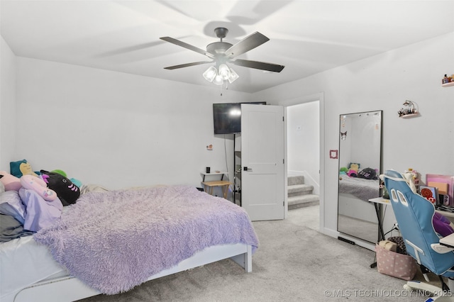 bedroom with light carpet and a ceiling fan