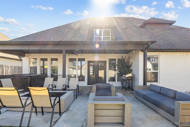 view of patio / terrace with a hot tub, grilling area, an outdoor hangout area, a ceiling fan, and fence