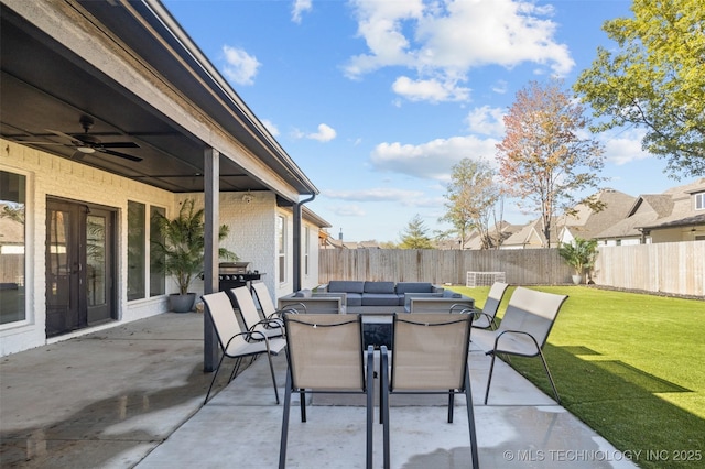 view of patio featuring outdoor dining space, a fenced backyard, and ceiling fan