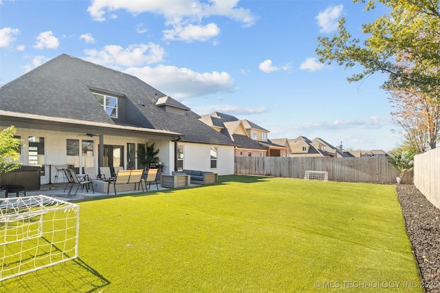 rear view of house featuring a lawn, a patio, a fenced backyard, roof with shingles, and an outdoor living space