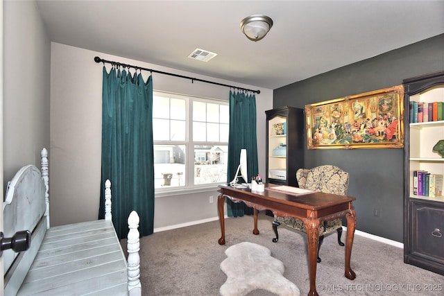 office featuring carpet floors, visible vents, and baseboards