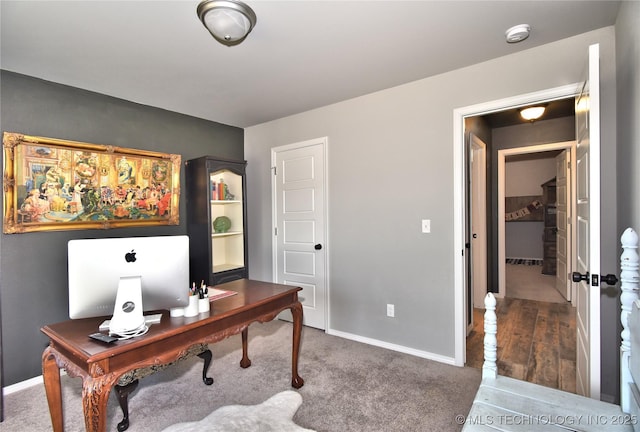 carpeted home office featuring baseboards