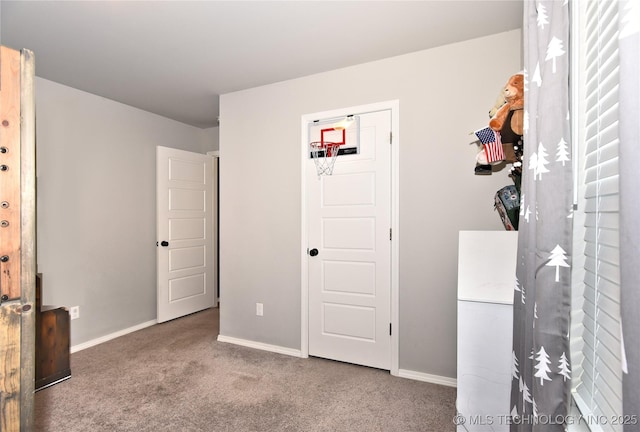 carpeted bedroom with freestanding refrigerator and baseboards