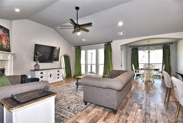 living room with dark wood-style floors, lofted ceiling, and visible vents