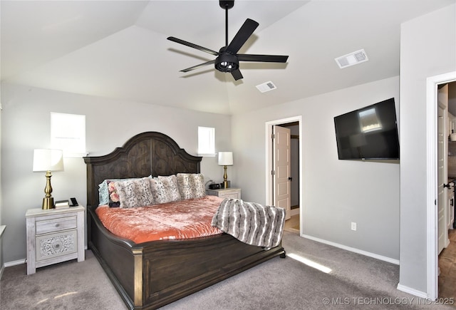 bedroom with carpet, visible vents, and vaulted ceiling