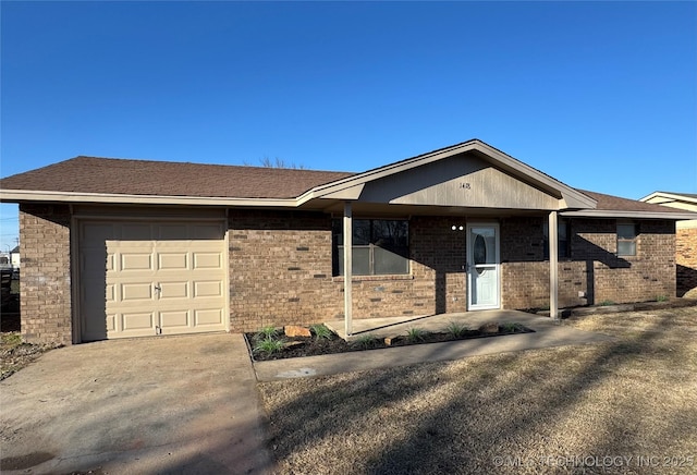 single story home featuring an attached garage, a shingled roof, concrete driveway, and brick siding