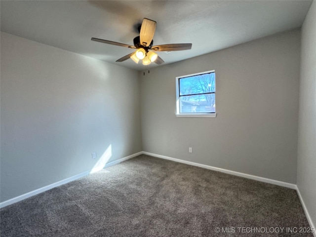 unfurnished room featuring dark colored carpet, ceiling fan, and baseboards