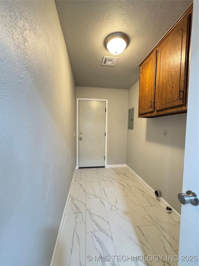 washroom featuring cabinet space, visible vents, baseboards, marble finish floor, and a textured ceiling