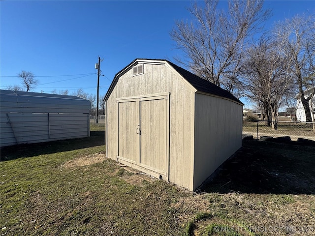 view of shed with fence