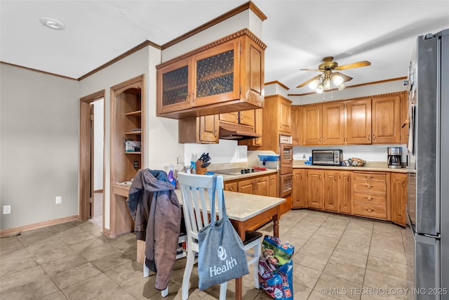 kitchen featuring glass insert cabinets, light countertops, ornamental molding, and appliances with stainless steel finishes