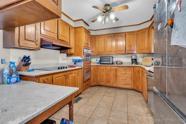 kitchen featuring brown cabinets, black electric cooktop, light countertops, crown molding, and under cabinet range hood