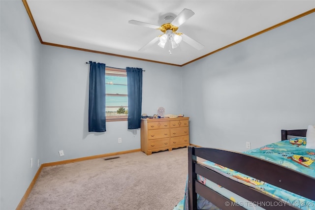 carpeted bedroom with baseboards, visible vents, ceiling fan, and ornamental molding