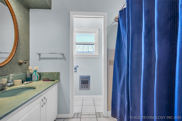 full bath with baseboards, a shower with shower curtain, heating unit, tile patterned flooring, and vanity