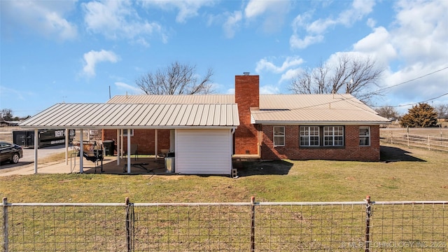 back of property with brick siding, a chimney, and fence private yard