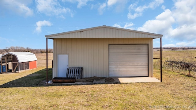 detached garage featuring fence