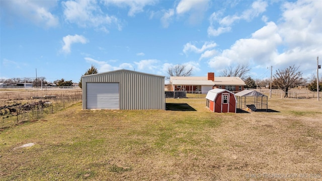 exterior space with a rural view, fence, and a lawn