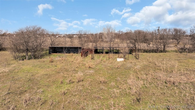 view of front of home with a pole building and a rural view