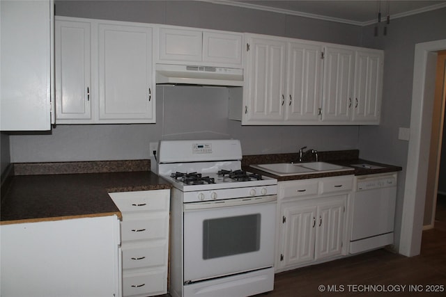 kitchen featuring white appliances, a sink, white cabinets, under cabinet range hood, and dark countertops